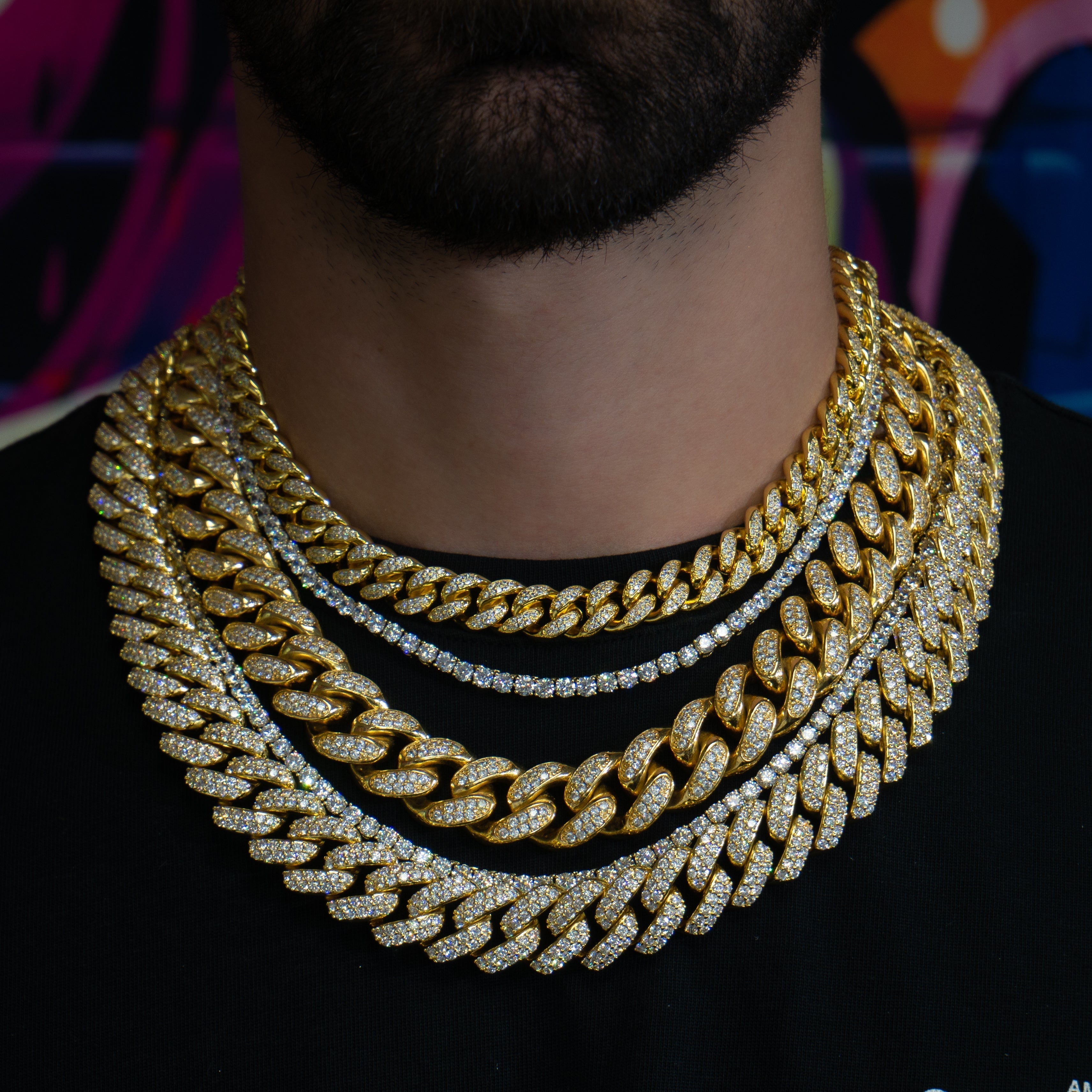 Layered SKRT iced-out cuban link and tennis chains shown on a male model