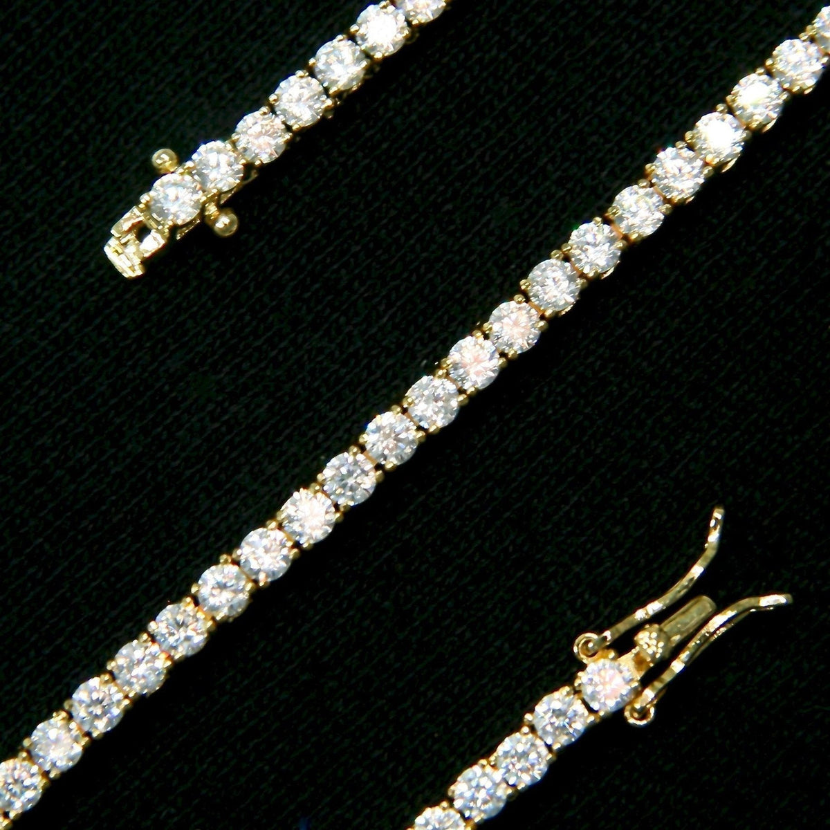 3mm Tennis Anklet in Yellow Gold, product detail showing round stones and open triple-lock clasp on black fabric