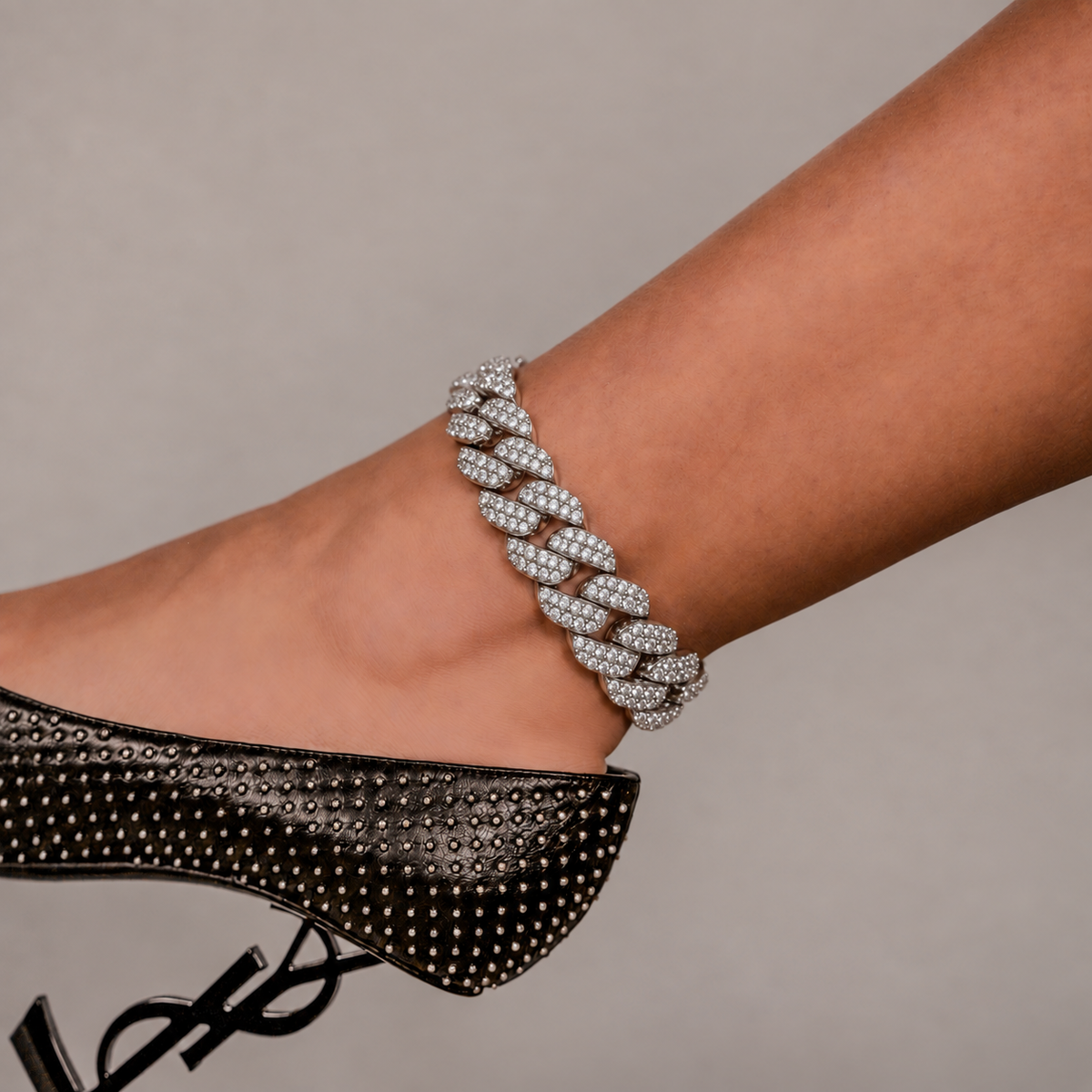 SKRT 18mm Flower Setting Cuban Link Anklet in White Gold shown on an ankle.