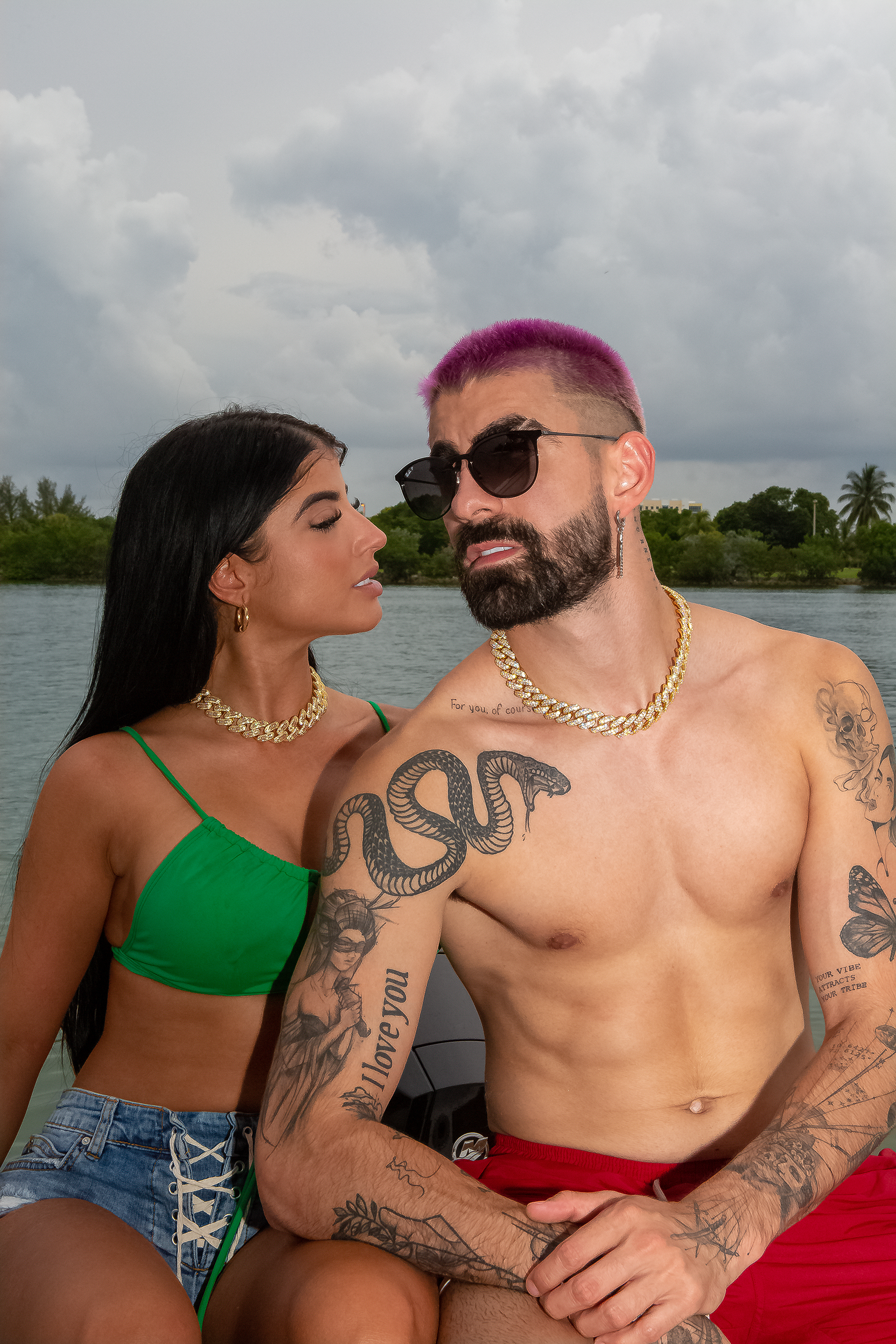 Couple wearing matched yellow gold cuban link chokers in a lifestyle setting