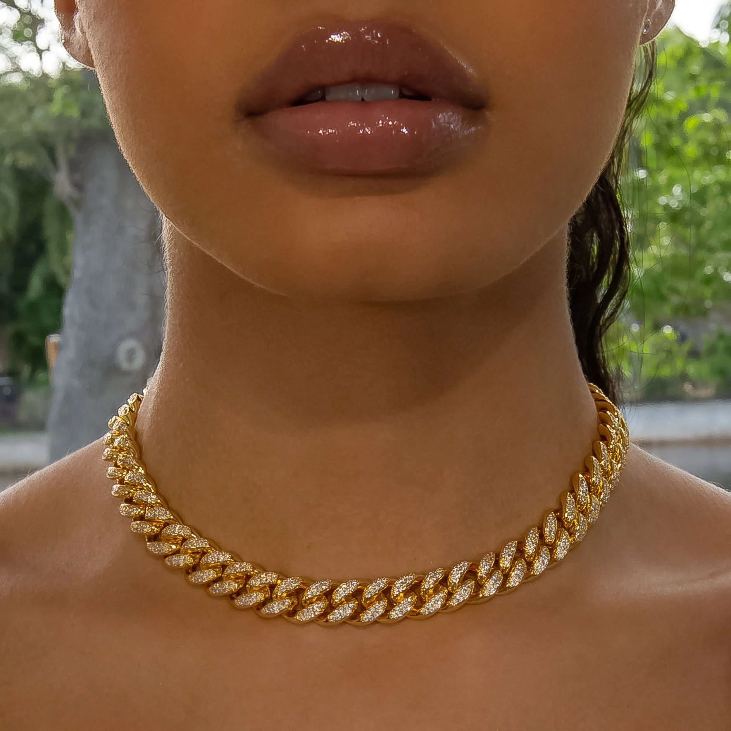 Iced out Yellow Gold Cuban link choker worn on the neck