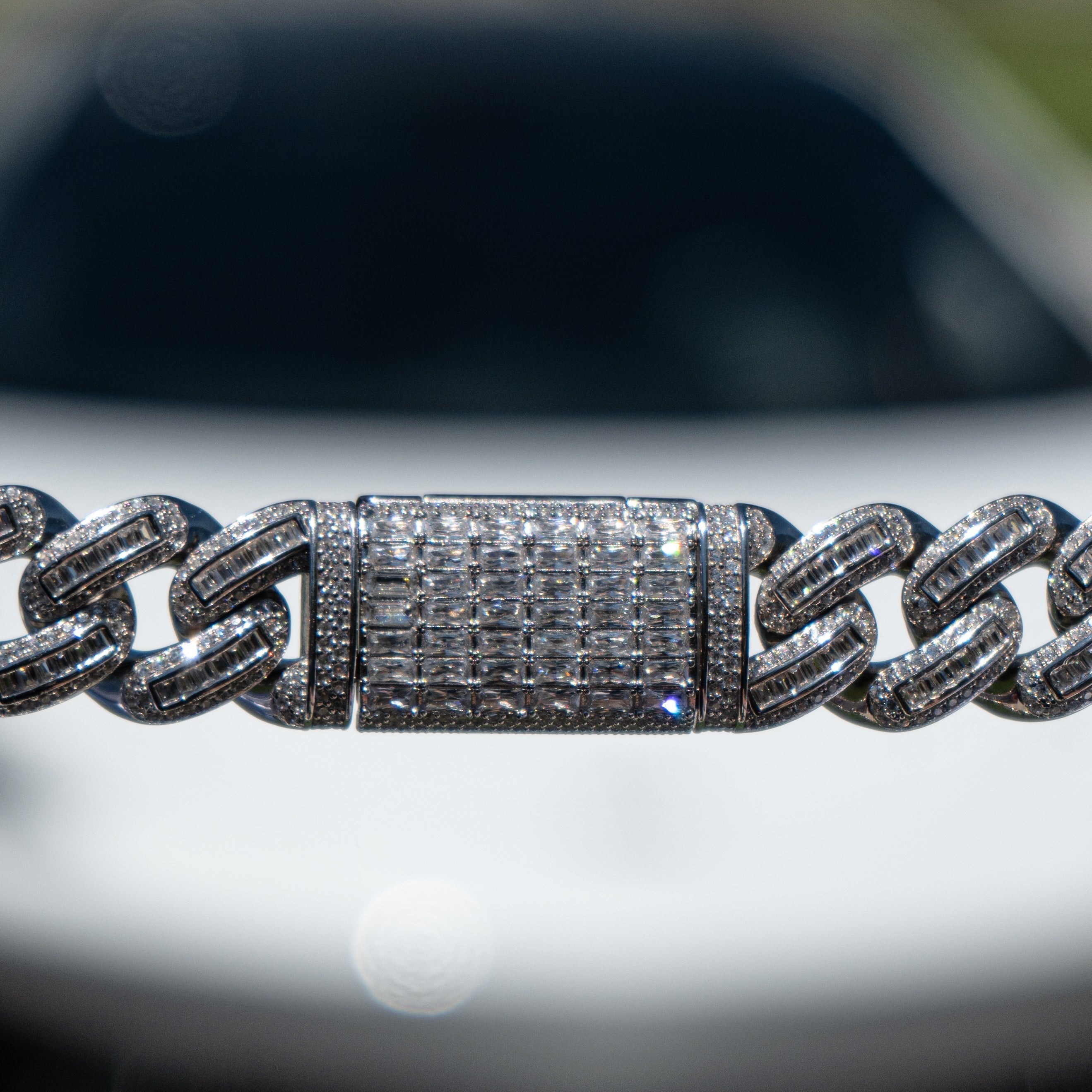 Iced out White Gold Bugatti link bracelet worn on the wrist