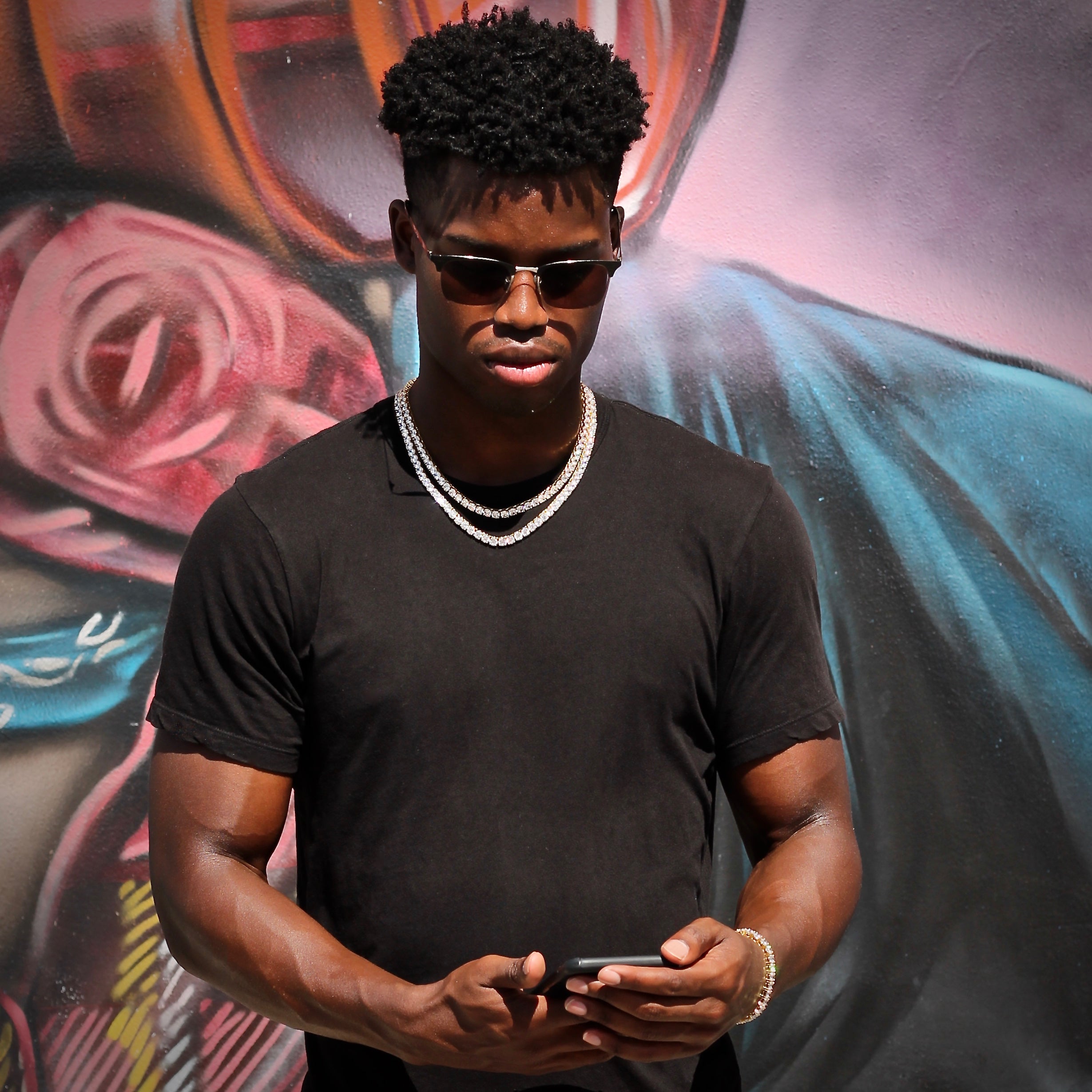 Layered SKRT tennis chains on a male model