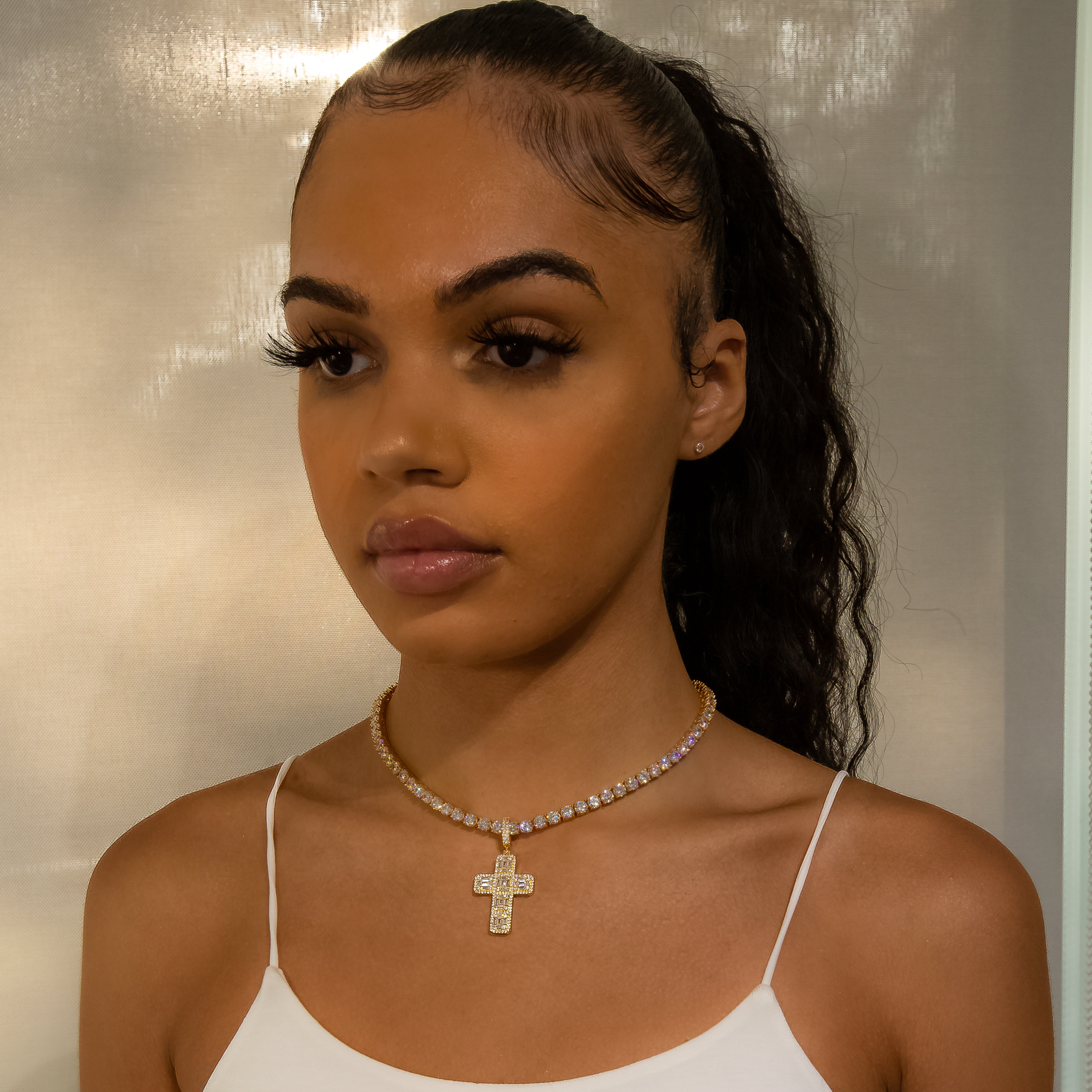 Iced Baguette Diamond Cross in Yellow Gold (view 2 of 6) · female-model