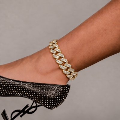 SKRT 18mm Flower Setting Cuban Link Anklet in Yellow Gold shown on an ankle.
