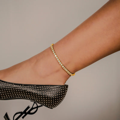 4mm Tennis Anklet in Yellow Gold worn around an ankle